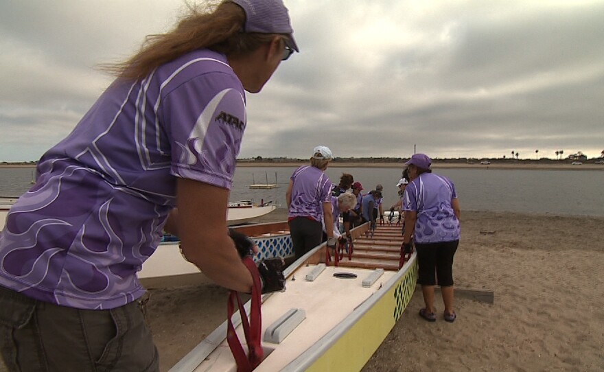 Cheance Adair leads the Team Survivor Sea Dragons as they put their boat in the water on Fiesta Island on July 1, 2014.