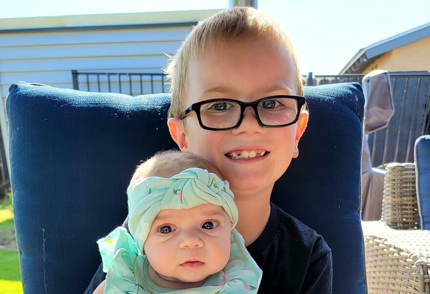 Nathan Lenz holds his baby sister, Stephanie Lenz, 2022.