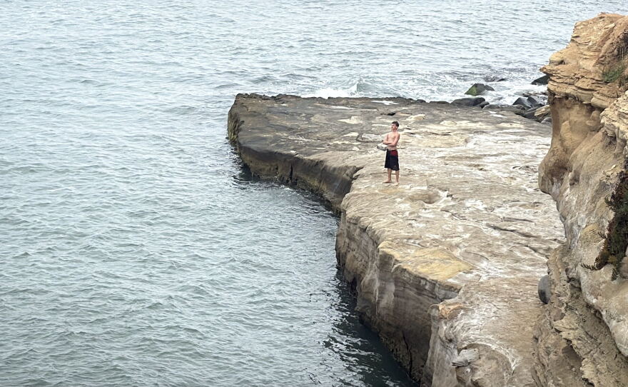 A young boy stands on a rocky outcropping near Pappy's Point at Sunset Cliffs, Aug.5, 2026.