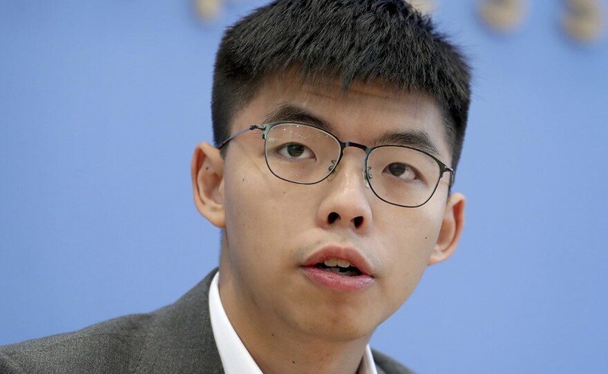 Hong Kong activist Joshua Wong addresses the media during a news conference in Berlin last month. Wong on Tuesday said Hong Kong authorities have disqualified him from upcoming local council elections.