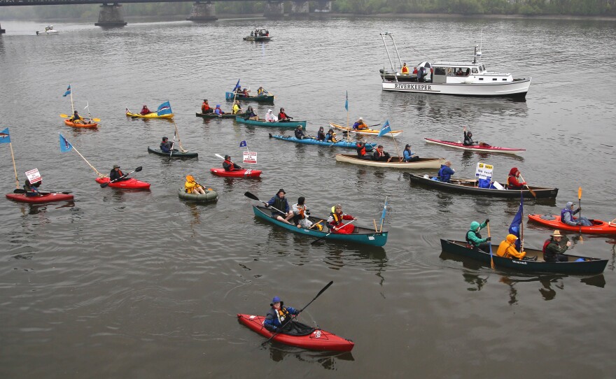 Opponents of oil trains and barges that service the Port of Albany paddle along the Hudson River on Friday in Albany, N.Y. The demonstration was part of the Break Free from Fossil Fuels movement.