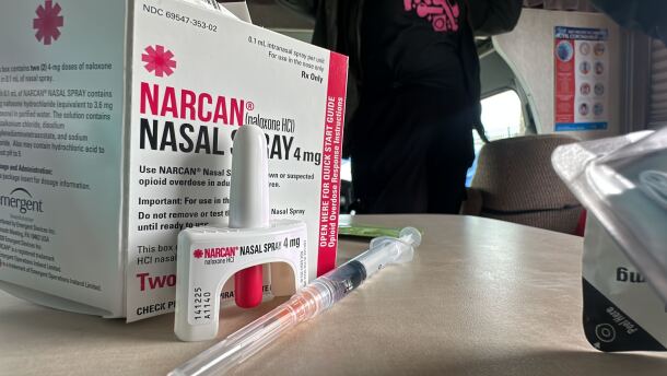 Nasal (left) and injected (middle) doses of naloxone sit on a table inside of a recreational vehicle used by the San Diego Harm Reduction Coalition.