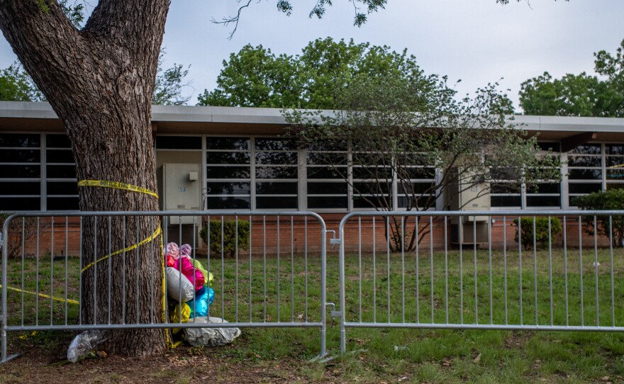 Balloons are seen wrapped around a tree in caution tape at Robb Elementary School on May 31, 2022 in Uvalde, Texas, a week after the school shooting.