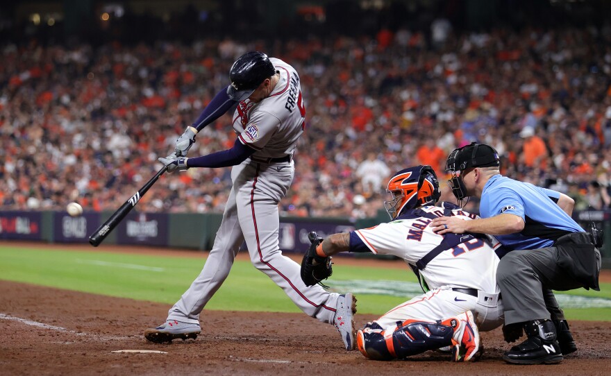 Freddie Freeman of the Atlanta Braves hits a home run against the Houston Astros during game six of the 2021 World Series. A report by Business Insider found that the league used two different types of baseballs during the 2021 season, one of which flew further.