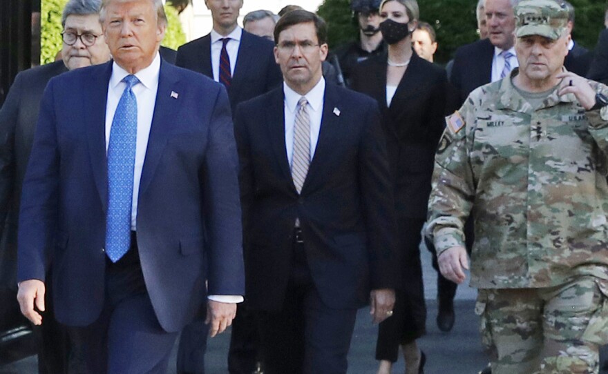 President Trump and his advisers, including Attorney General William Barr, walk through Lafayette Square on June 1 after it was cleared of protesters. Trump then posed for photos holding up a Bible in front of St. John's Episcopal Church.