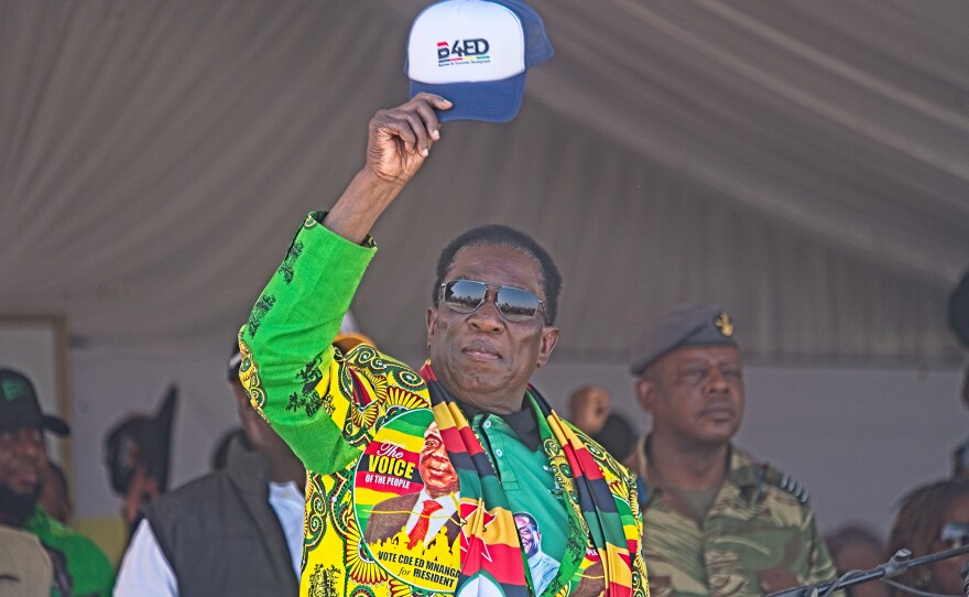 Zimbabwe's president, Emmerson Mnangagwa, lifts his hat to the crowd at his final reelection campaign rally on Saturday, ahead of general elections on Wednesday. Mnangagwa is confident of victory, but critics have said rising voter intimidation and bias of state institutions in favor of the ruling party risk the credibility of the election.