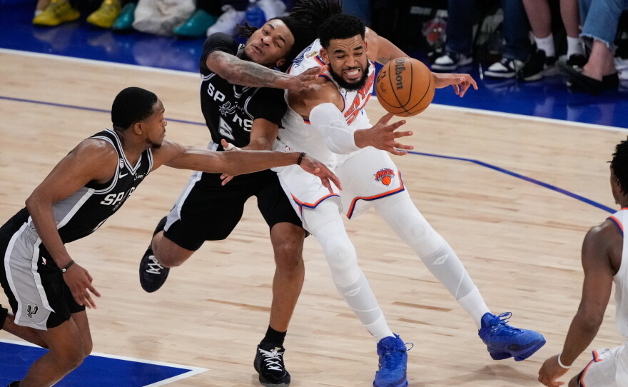 New York Knicks center Karl-Anthony Towns, right, and San Antonio Spurs guard Stephon Castle (5) battle for the ball during the second half of Game 4 of the NBA Finals basketball series, Wednesday, June 10, 2026, in New York.
