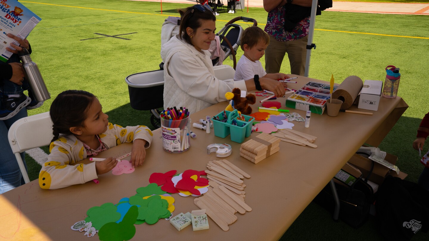 Families make garden markers with KPBS Kids at Be My Neighbor Day across the street from the KPBS station on Saturday, April 6 in San Diego, CA.