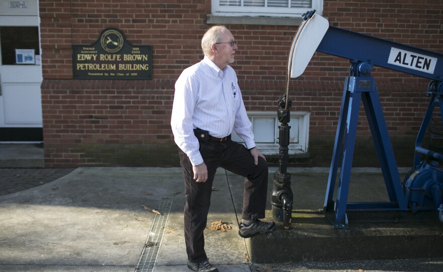 Dr. Robert Chase, former chair of the petroleum engineering program Marietta College, stands next to an oil rig on campus in Marietta, Ohio.
