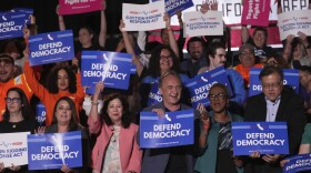 People await a news conference with California Gov. Gavin Newsom Thursday, Aug. 14, 2025, in Los Angeles.