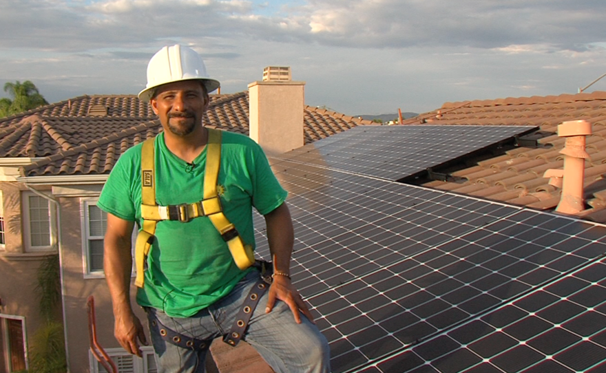 Phil Salas, project manager for the solar panel installation company Home Energy Systems, stands in front of panels he and his crew installed on a San Diego home, Oct. 12, 2015.