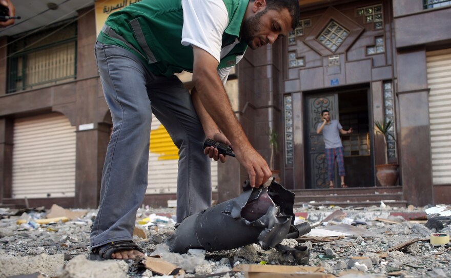 A Palestinian security guard checks the remains of an Israeli missile that hit a building in Gaza City following an airstrike on Friday. Israeli has carried out multiple ground operations in Gaza since 2000, but has never fully suppressed Palestinian rocket fire or closed off smuggling tunnels.