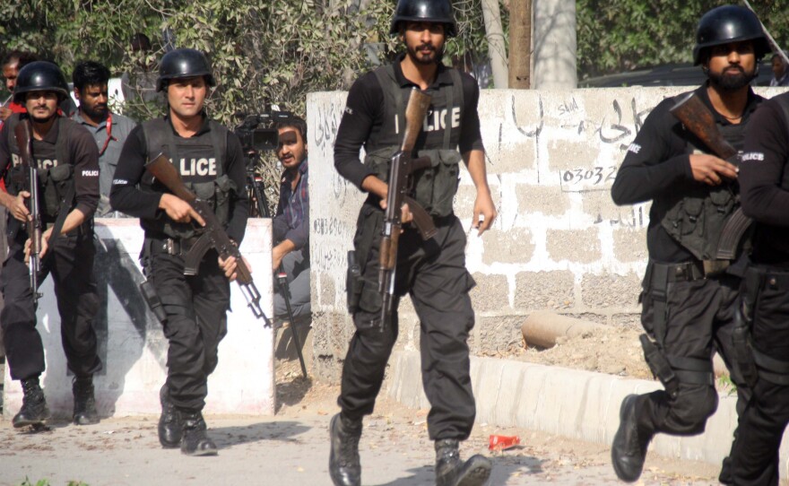 Pakistani police respond outside the Chinese consulate after an armed attack on Nov. 23.