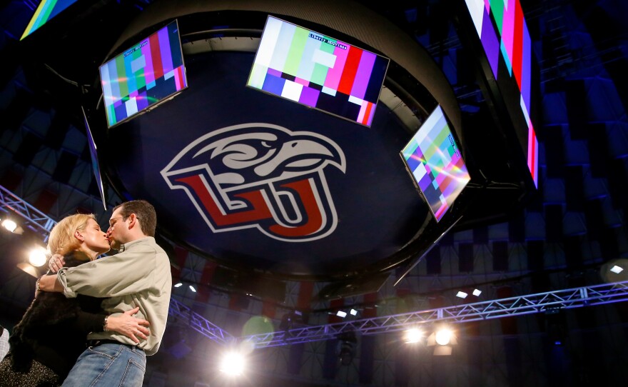 Sen. Ted Cruz kisses his wife, Heidi, during a walk-through Sunday night at Liberty University. Cruz plans to announce his presidential campaign at the school Monday.