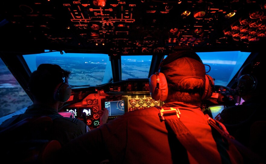 Crew members on board a RAAF AP-3C Orion crossing the coast of Perth, having just completed an 11-hour search mission for missing Malaysia Airways flight MH370.