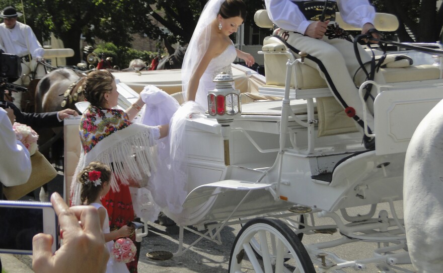 The bride's sister helps her into a carriage after the couple receives their blessings. Renee Stella Zieba and Michael John Livernois were married in Chicago.