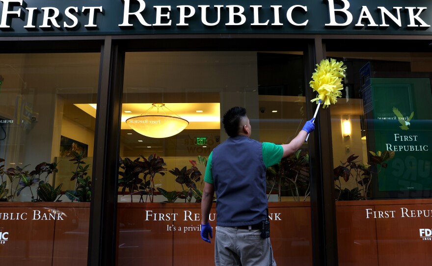 A worker cleans the outside of a First Republic bank in San Francisco.