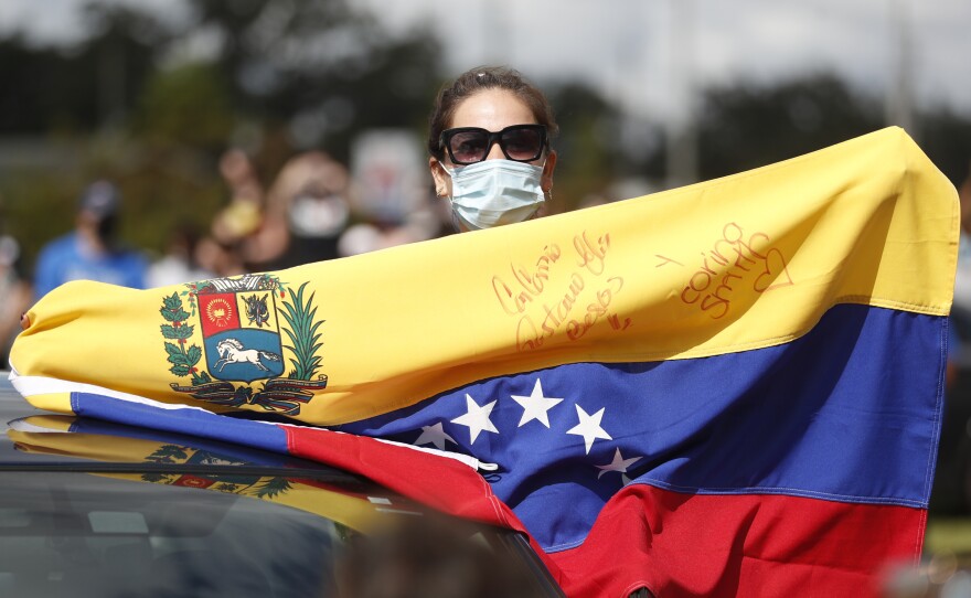 A Joe Biden supporter with a Venezuelan flag cheers during a Biden campaign event at Camping World Stadium on October 27, 2020 in Orlando, Florida.