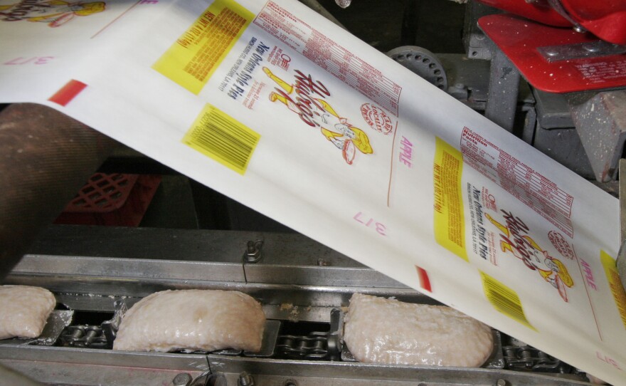 This 2007 picture taken before the fire that destroyed Hubig's Pies shows fresh glazed fruit-filled pies being wrapped for delivery at the bakery in New Orleans.