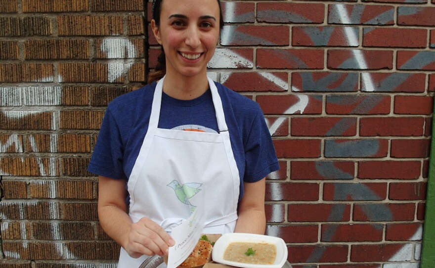 Mana Heshmati, founder of the Detroit-based Peace Meal Kitchen, stands outside of the Detroit City Distillery in Eastern Market during a fundraising event for the ACLU of Michigan. Within two hours, she sold out of her a la carte menu, which included ghormeh sabzi, a Persian beef stew, a vegetarian cream of barley soup, and shirini keshmeshi, delicate rosewater raisin cookies.