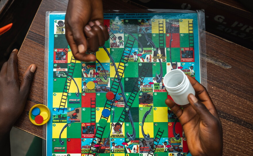 The game "Schisto & Ladders" is introduced to students in an elementary school in a part of Nigeria where the neglected tropical disease schistosomiasis, spread by parasitic worms, affects many residents. This version of the classic "Chutes & Ladders" games aims to teach children how to avoid getting infected — and details of the treatment for those who catch it.