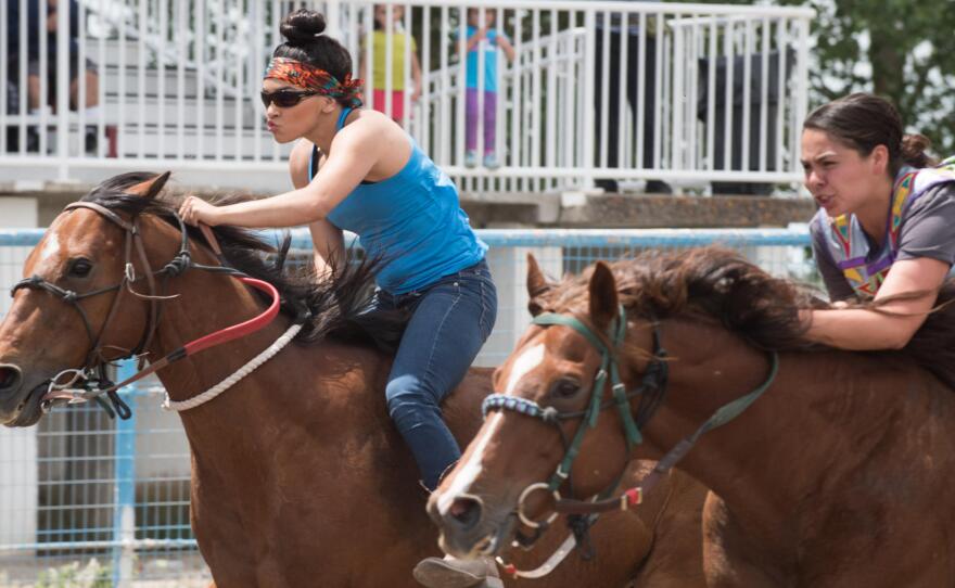 Raedeyn Teton, left, and Jessica Broncho, race side-by-side in an Indian Relay on the Fort Hall Indian Reservation in Idaho.