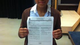Lupe Sandoval holding her application
