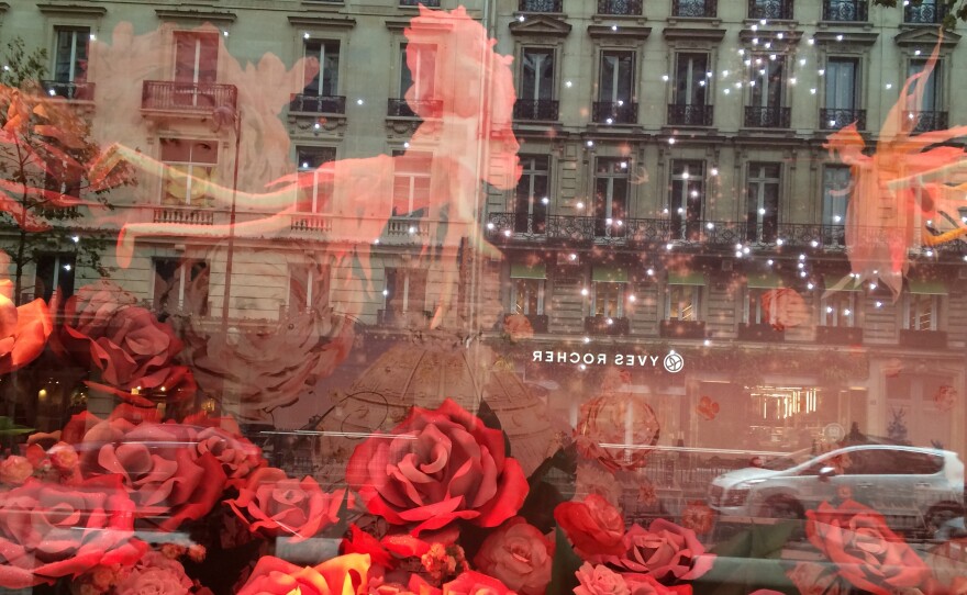 A Christmas display in a window on Paris' Boulevard Haussmann hints at the shopping season — but those who enter the stores are facing security checks.