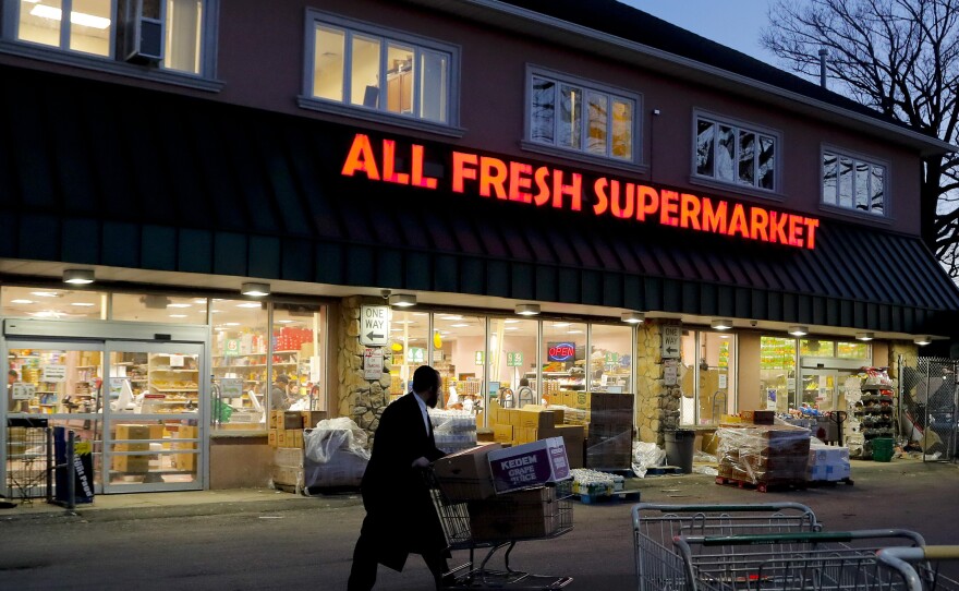 A man walks through the parking lot of a supermarket in New York's Rockland County, which has declared a state of emergency over a measles outbreak.