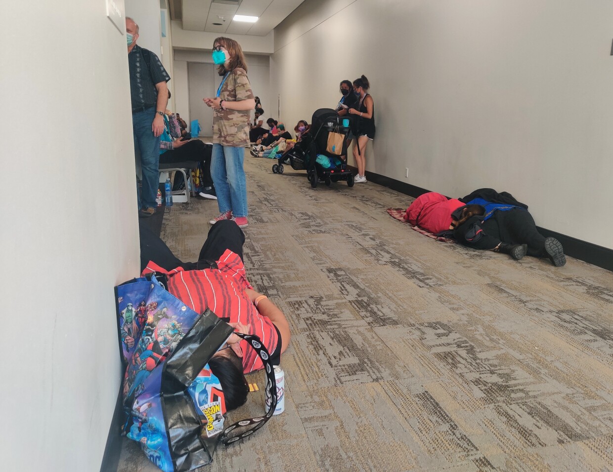 Some attendees take a quick nap in a hallway before their next activity, July 24, 2022.