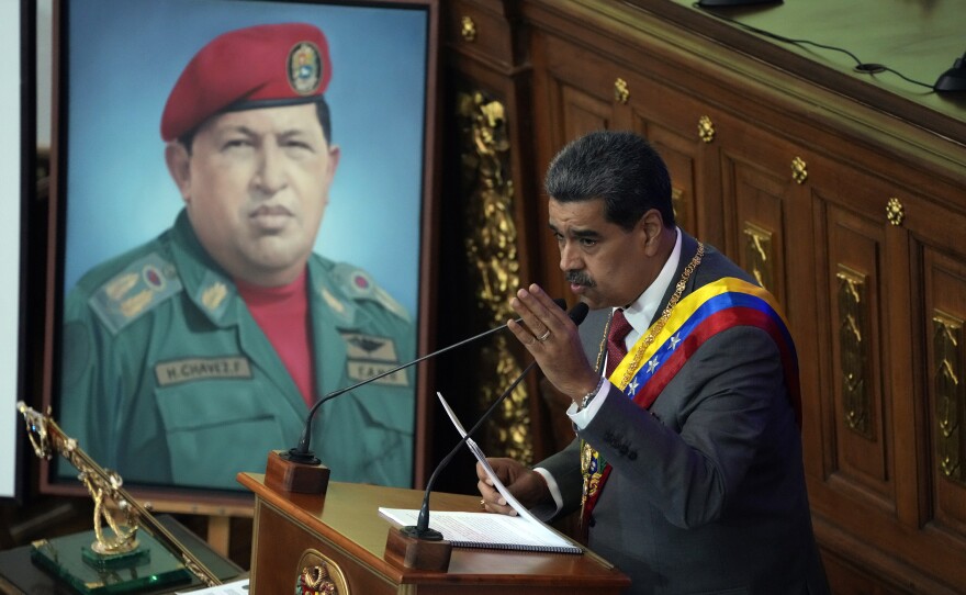Venezuelan President Nicolás Maduro delivers his annual address at the National Assembly in Caracas, Venezuela, Jan. 15. Behind is an image of late President Hugo Chávez.