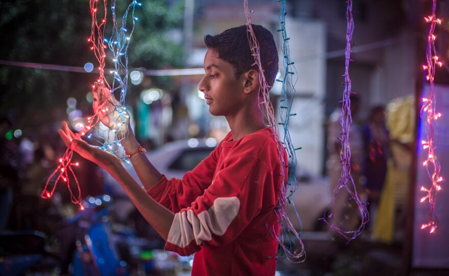 Aniket buys decorations for his house for a religious holiday.