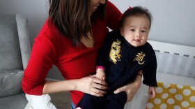 The journalist with her half-Chinese daughter, Eva, on the Lunar New Year. Eva's outfit says "dragon" in Chinese.