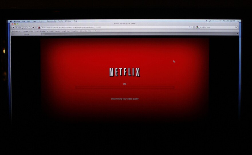 A movie selected from Netflix begins to download on a home computer screen. Other companies, including Amazon, are trying to woo more customers for online video services.