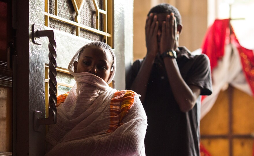 Konjit, 26, prays at the entrance to Kidist Selassie (Holy Trinity) Cathedral in Addis Ababa, Ethiopia. Konjit had an abortion several days earlier and says that because of her "sin" she will not allow herself inside the church.