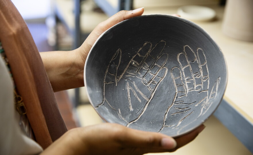 Sellars displays a bowl she made in the ceramics studio.