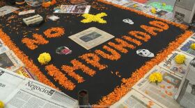 Marigold petals frame newspapers, a visual to honor journalists who have passed for Día de Muertos in Tijuana on Oct. 31, 2025