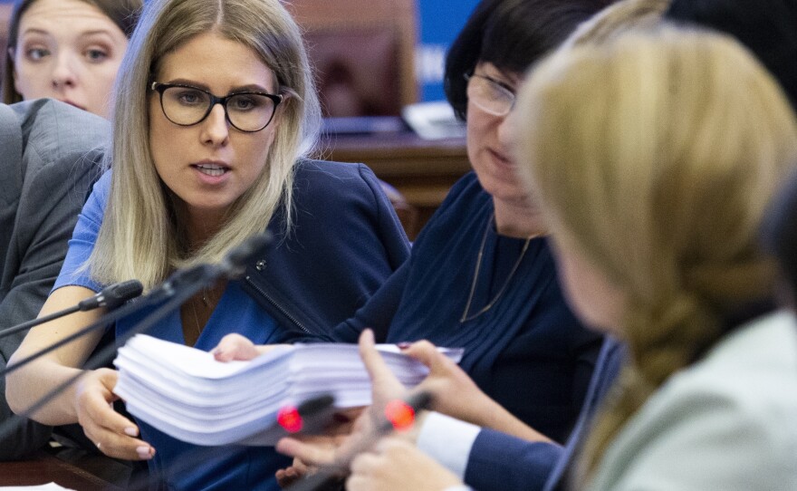 Sobol (left) gives election documents to Ella Pamfilova, head of the Russian Central Election Commission (right, back facing camera), during a meeting with opposition candidates at the commission in Moscow on July 23.