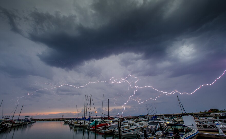 Lightning streaks across the sky over Port Washington, Wis., on Thursday. A phenomenon called a "heat dome" is causing temperatures well above 100 degrees, according to the National Weather Service.