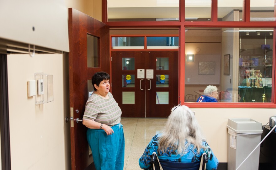 After a class Eagle teaches to the visually impaired on how to use technology, she helps her students navigate their way into the hall. In addition to her volunteer work, Eagle plays piano at the center.