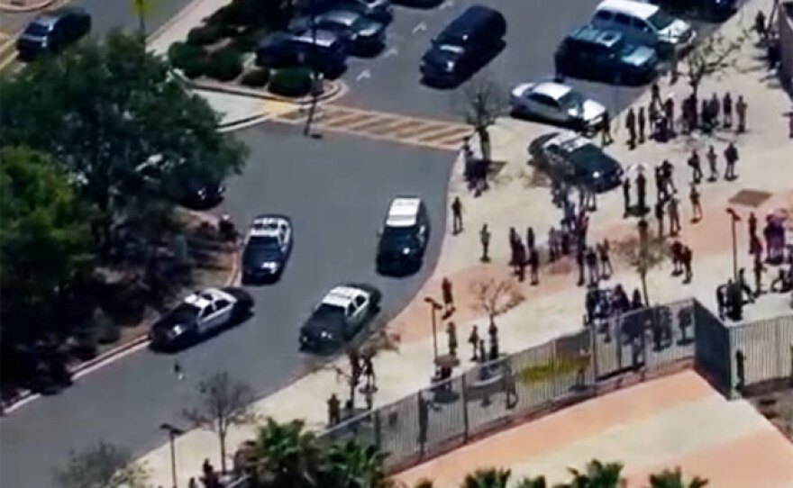 San Diego police officers are pictured surrounding Rosa Parks Elementary School during a brief lockdown, July 7, 2015.