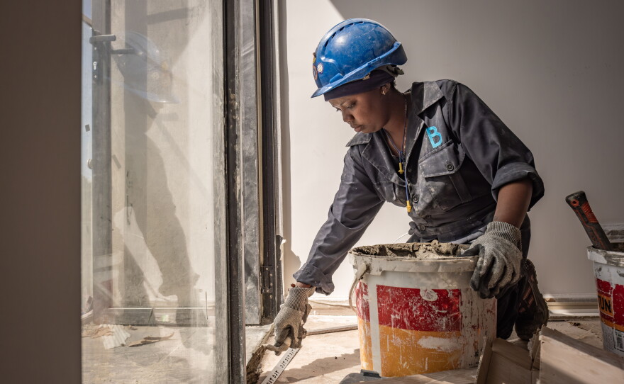 Tiler Margaret Klamiatha works at a construction site at the Tatu City development on the edge of Nairobi.