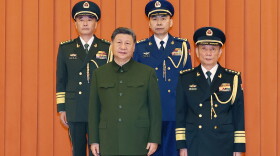 In this photo released by Xinhua News Agency, Chinese President Xi Jinping, bottom left, who is also Chairman of the Central Military Commission (CMC) poses for photos with newly promoted generals Wang Shuguang, top left and Wang Gang, top right while Zhang Shengmin, Vice Chairman of the CMC stands at the right in Beijing, on Friday, July 3, 2026.