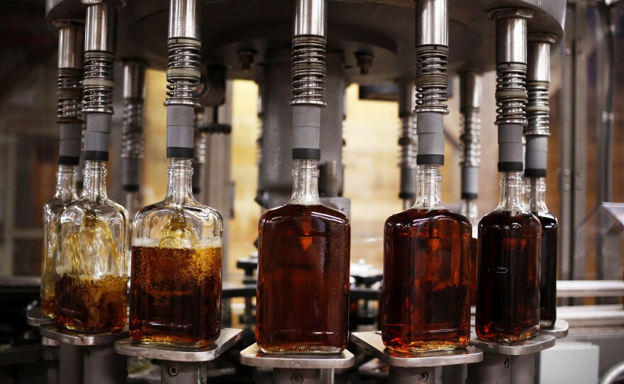 Bottles of single barrel bourbon are filled on the bottling line at a distillery in Kentucky, the center of the bourbon universe. But some distillers are looking to other spirits, too.