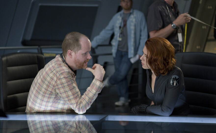 Our beloved geek king, Joss Whedon, on the set of "The Avengers" with Scarlett Johansson.