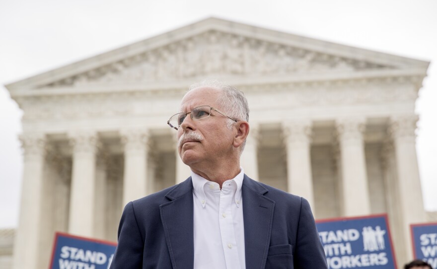 Plaintiff Mark Janus stands outside the Supreme Court after the court rules in a setback for organized labor that states can't force government workers to pay union fees.