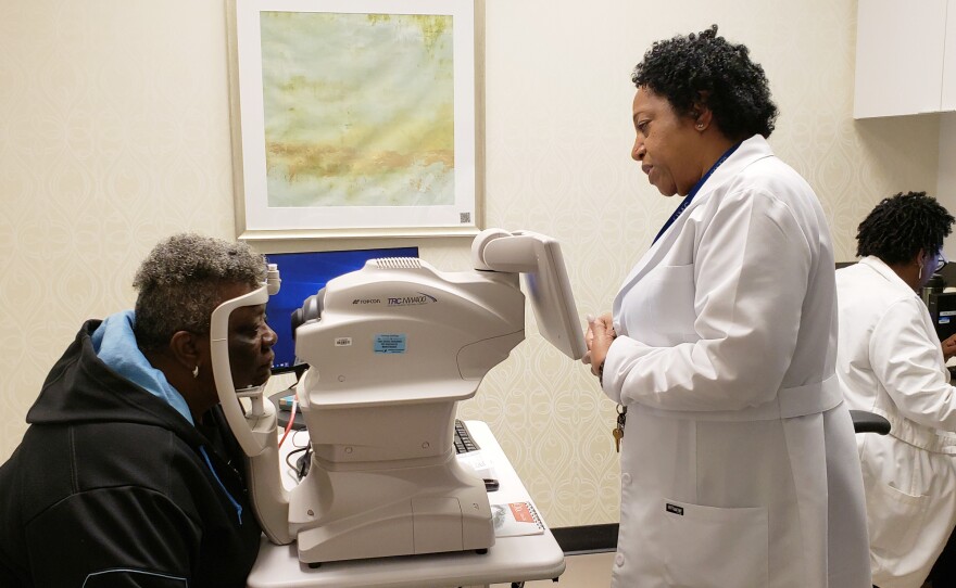 Nurse practitioner Debra Brown guides patient Merdis Wells through a diabetic retinopathy exam at University Medical Center in New Orleans.