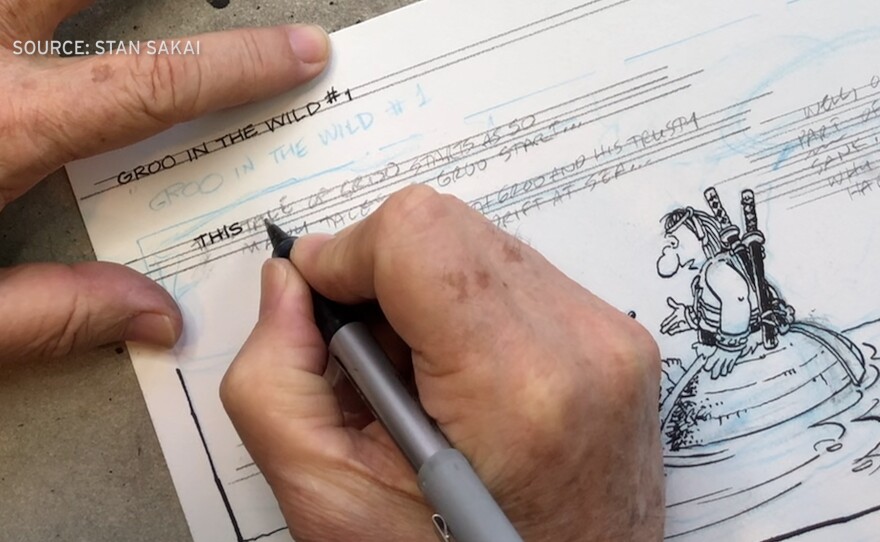 Stan Sakai inking the letters for a panel of "Groo." Undated photo.