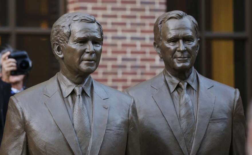 Statues of former Presidents George W. Bush (left) and George H.W. Bush greet visitors to the George W. Bush Presidential Center in Dallas.