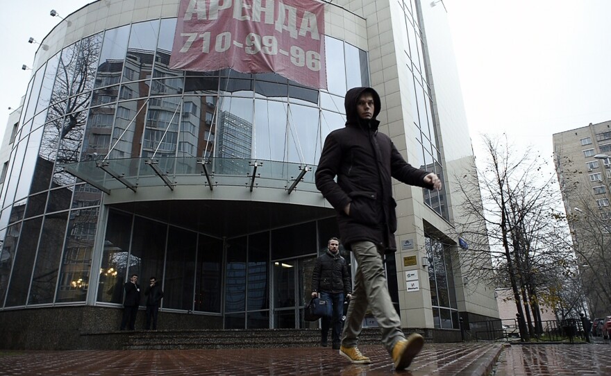 A man walks outside the building that houses Russia's antidoping agency (RUSADA) in Moscow Tuesday. The World Anti-Doping Agency (WADA) has suspended the accreditation for the Moscow anti-doping laboratory.
